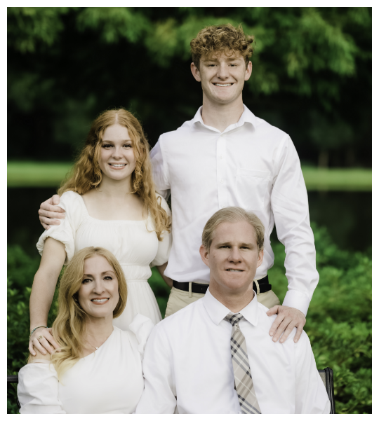 Holden Hoggatt family with son and daughter sittiing in front of Holden and his wife